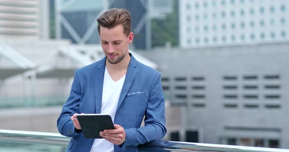 Businessman work on tablet computer at outdoor