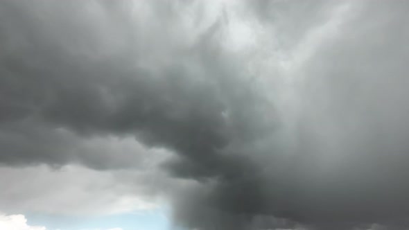 Rain clouds fly away quickly and the blue sky becomes, time-lapse alt