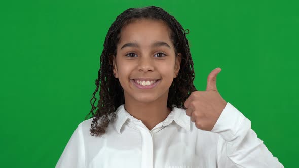 Closeup Portrait of Happy Smiling African American Teen Girl Showing Thumbs Up Looking at Camera on