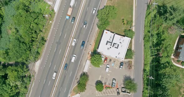 Asphalt Road Going Through Small Typical Settlement and Green Trees on the Horizon Live Aerial View