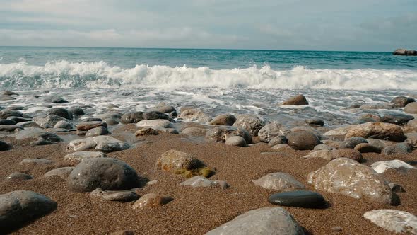 Big Waves Are Crashing on Stones and Spraying in Slow Motion. Beautiful Beach in Crimea with Stones