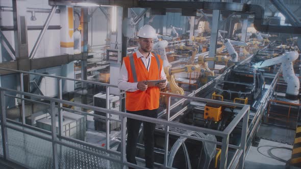 Male Engineer Working on Car Factory