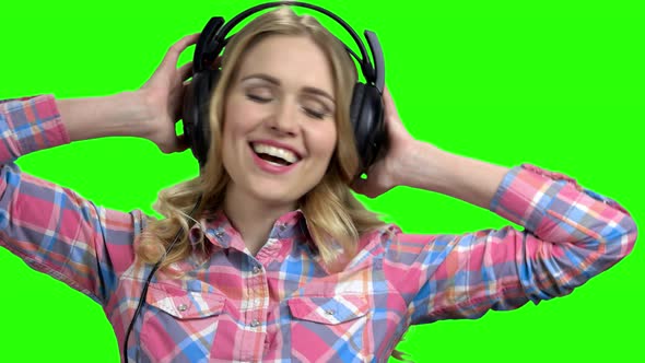 Woman with Headphones Enjoying Listening To Music