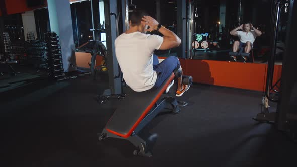 Athlete Man Do Abdomen Muscles Workout Exercise on Training Apparatus in Gym