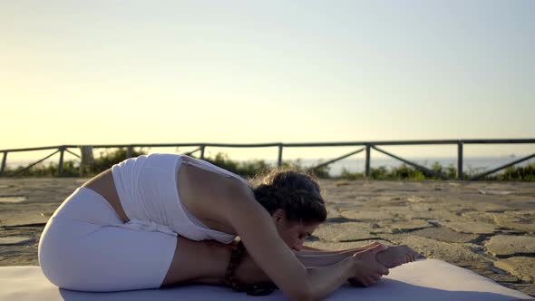 Slow motion shot of young woman doing yoga