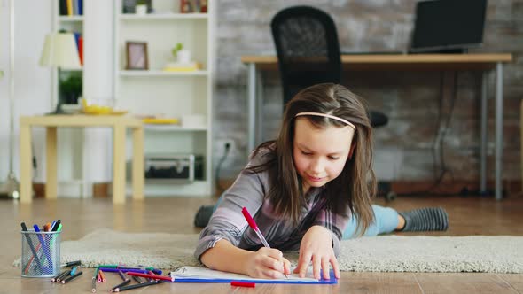 Cheerful Little Girl Lying on the Floor