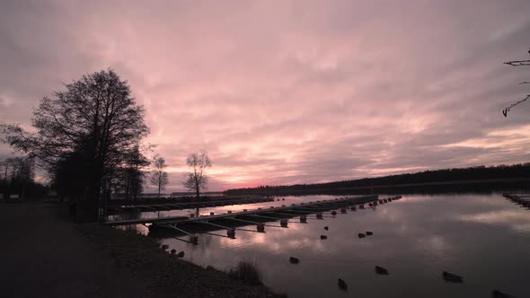 Timelapse of sunset over small harbor