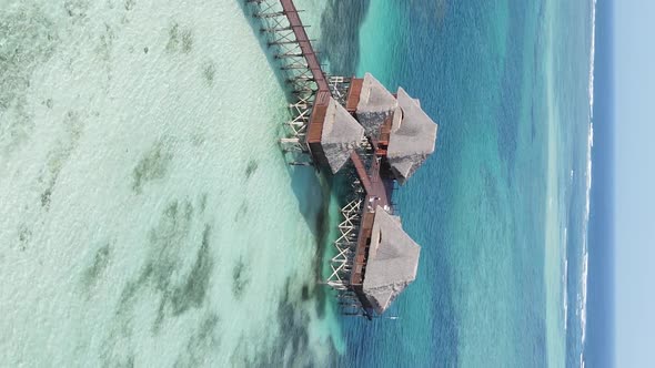 Vertical Video House on Stilts in the Ocean on the Coast of Zanzibar Tanzania Aerial View