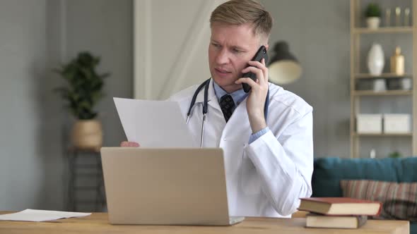 Doctor Talking on Phone with Patient Discussing Treatment Plan