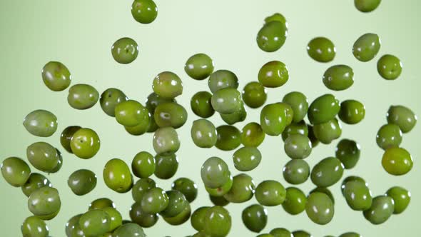 Super Slow Motion Shot of Flying Olives and Water Side Splash at 1000 Fps