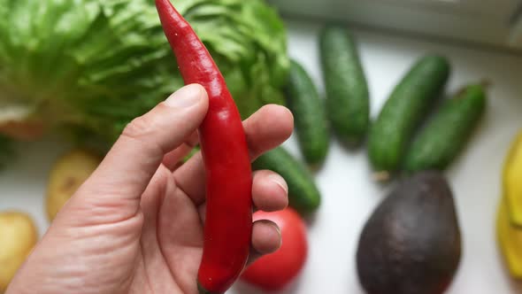 Male Hand Holding Chili Pepper Concept of Proper Nutrition
