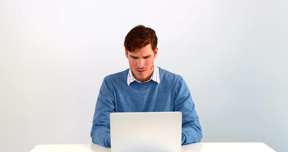 Man using laptop on table against white background