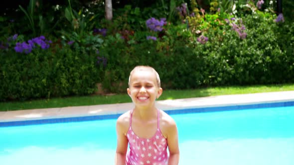 Girl jumping near swimming pool