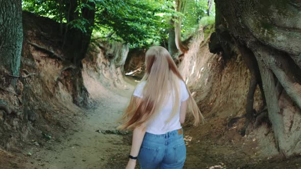 Back View of Pretty Blonde Woman Running in Roots Gorge