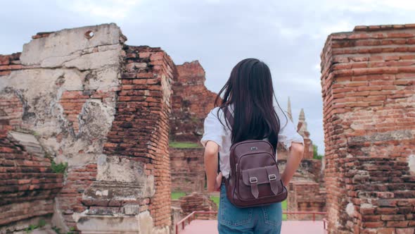 Japanese backpacker female enjoy her journey at amazing landmark in traditional city.