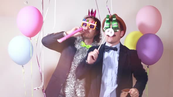 Two male friends having fun with props