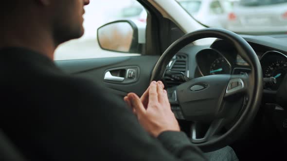 Man Driving in Innovative Automated Car Using Selfparking Autopilot for Parking on Parking Lot