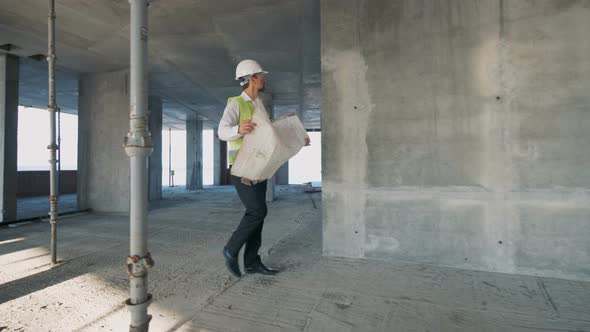 Builder Architect Looks at a Building Plan Close Up