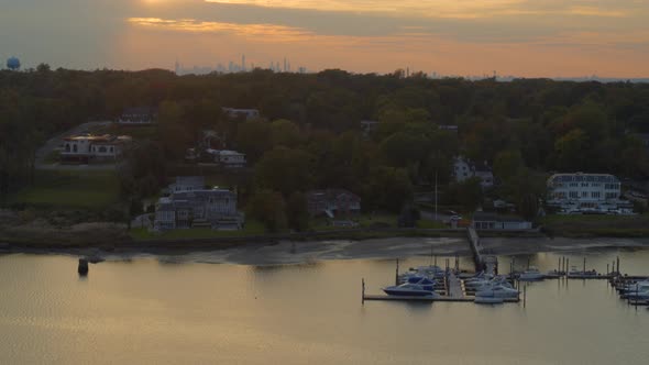 Rising Aerial From Boats Docked at Marina to New York City Skyline at Sunset