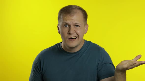 Portrait of Young Caucasian Man Posing in T-shirt. Dissatisfied Guy Puts Hand on Face, Facepalm