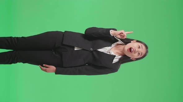 Asian Business Woman Thinking About Something Then Raising Her Index Finger On Green Screen