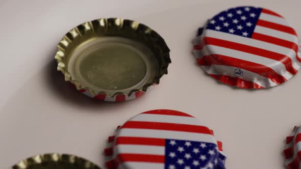 Rotating shot of bottle caps with the American flag printed on them