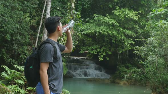 Hiker Drinking Water In Nature