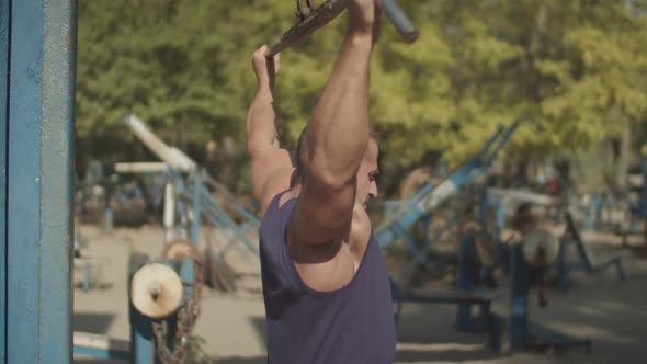 Fit Man Working Out Lat Pulldown Training Outdoors