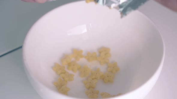 Crunchy Cereals in Star Shape Falls Down From Packet