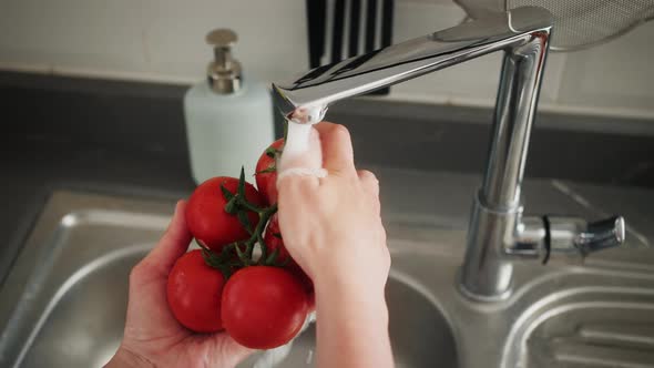 Washing Tomatoes with Tap Water in the Kitchen at Home Preparing Healthy Fresh Salad