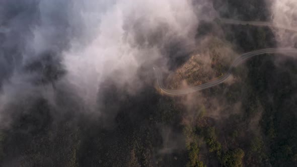 Cinematic Drone Footage on Cloudscape Flying Above Green Landscape and Highway