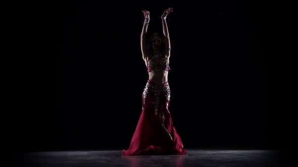 Traditional Oriental Belly Dancer Woman Dancing . Black Background. Slow Motion