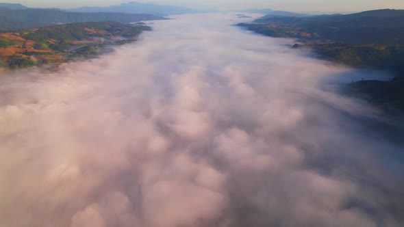 4K Aerial view from drone over mountains and sea of fog