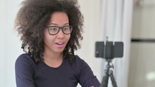 African Woman Recording Video on Smartphone