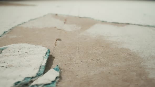Plasterboard with Torn Wallpaper and Holes in Room Macro