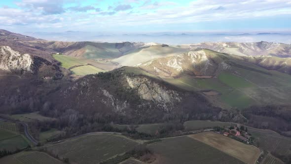 Aerial view over Italian hills with mist and clouds
