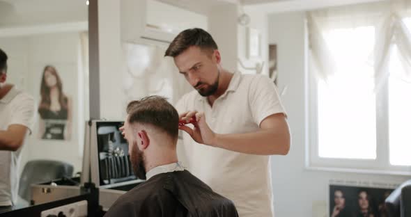 Closeup Male Cutting Hair with Scissors Getting the Services of a Hairdresser