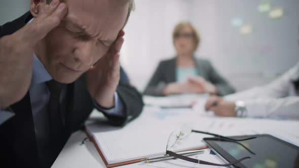 Male Worker has Migraine Attack Caused by Stress and Exhaustion at Workplace