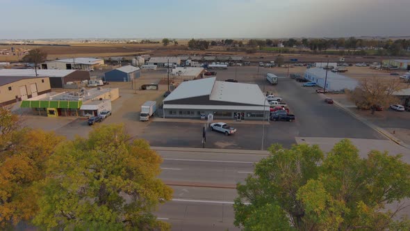 An industrial park in a rural community establishing shot with drop into trees. late fall (autumn)