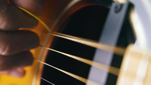 Guitarist Plays on Metal Bass String of Acoustic Guitar