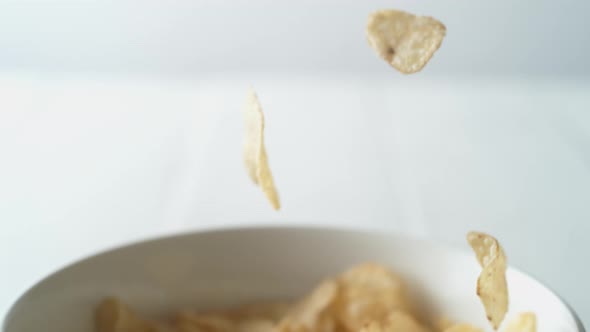 Putting potato chips in a bowl. Slow Motion.