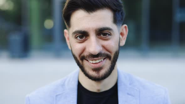 Face Portrait of Attractive Joyful Young Caucasian Bearded Man in Business Formal Suit Smiling