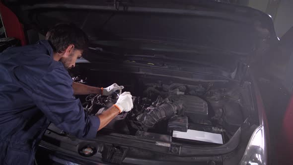 Repairman Using Wrench While Replacing Oil Filter