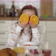 Little Girl with Fresh Orange Having Fun During Breakfast - VideoHive Item for Sale