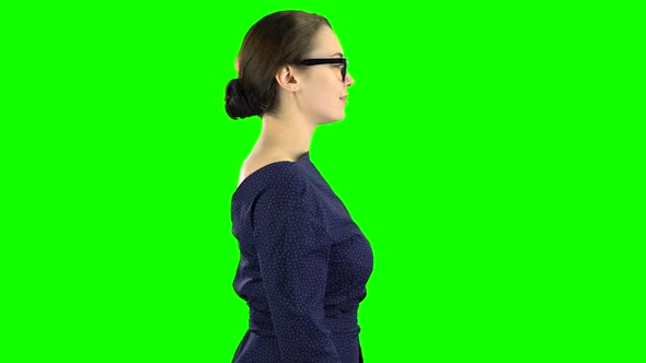 Business Lady Is Walking and Waving To Her Friends. Green Screen. Side View