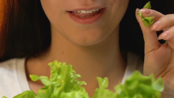 Woman Eating Fresh Lettuce and Smiling, Vegetarian Diet, Avoiding Meat Meals