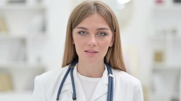 Portrait of Friendly Young Doctor Talking on Video Call 