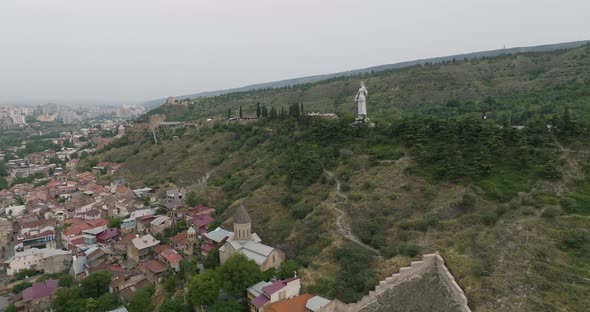 Mother of Georgia statue on the Sololaki hill during an overcasted day.