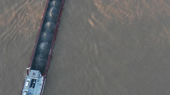 AERIAL: Overhead View of Cargo Boat in Beautiful Sunlight 