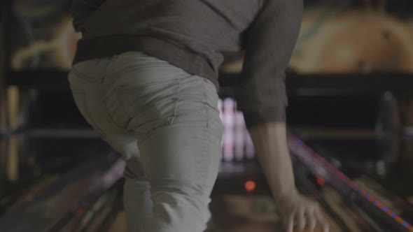 Back of a player throwing a bowling ball